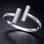 Silver ring with diamond accents on a dark background