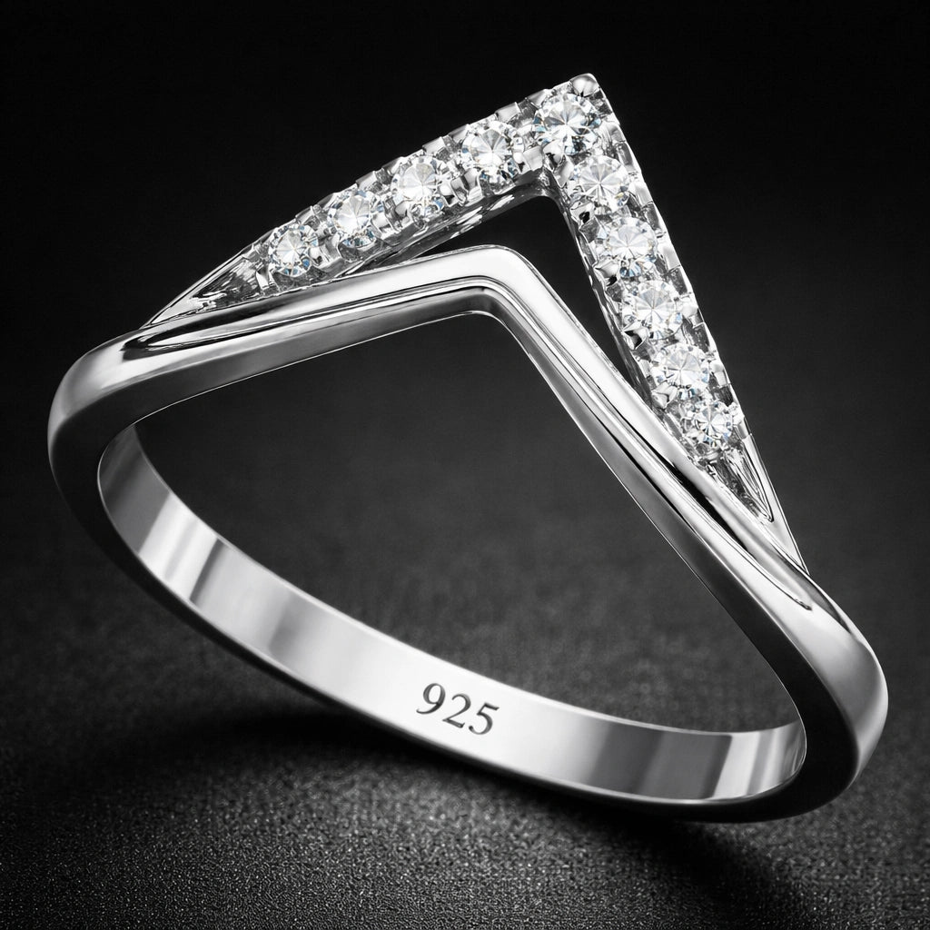 Silver ring with diamond accents on a dark background