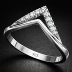 Silver ring with diamond accents on a dark background