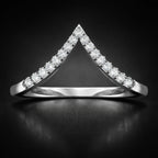 Diamond-studded triangular ring on a black background