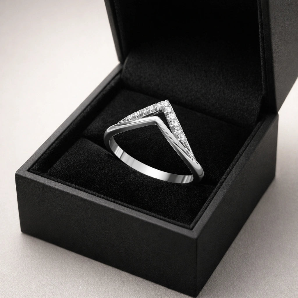 Silver ring with gemstones in a black box