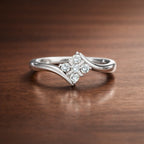 Silver diamond ring on a wooden surface