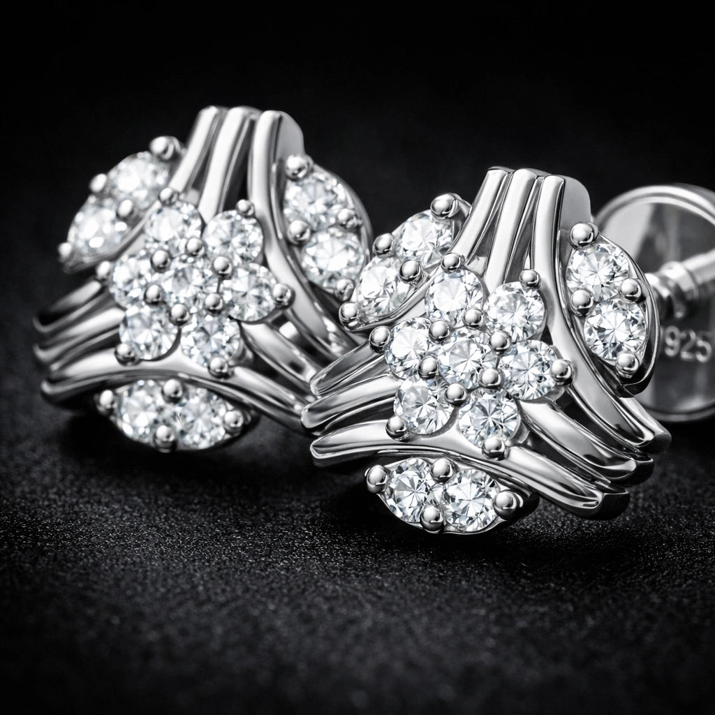 Silver earrings with floral design on a dark background