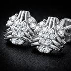 Silver earrings with floral design on a dark background