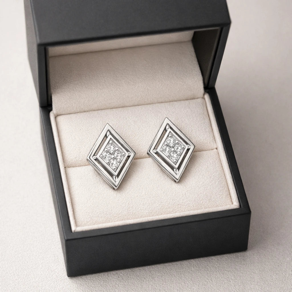Diamond stud earrings in a black jewelry box on a light gray background