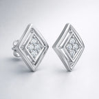 Pair of diamond-shaped silver earrings on a light gray background