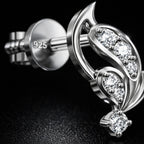 Silver earring with gemstones on a black background