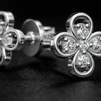 Macro detail of floral diamond stud earrings showing 925 sterling silver hallmark and precision stone setting
