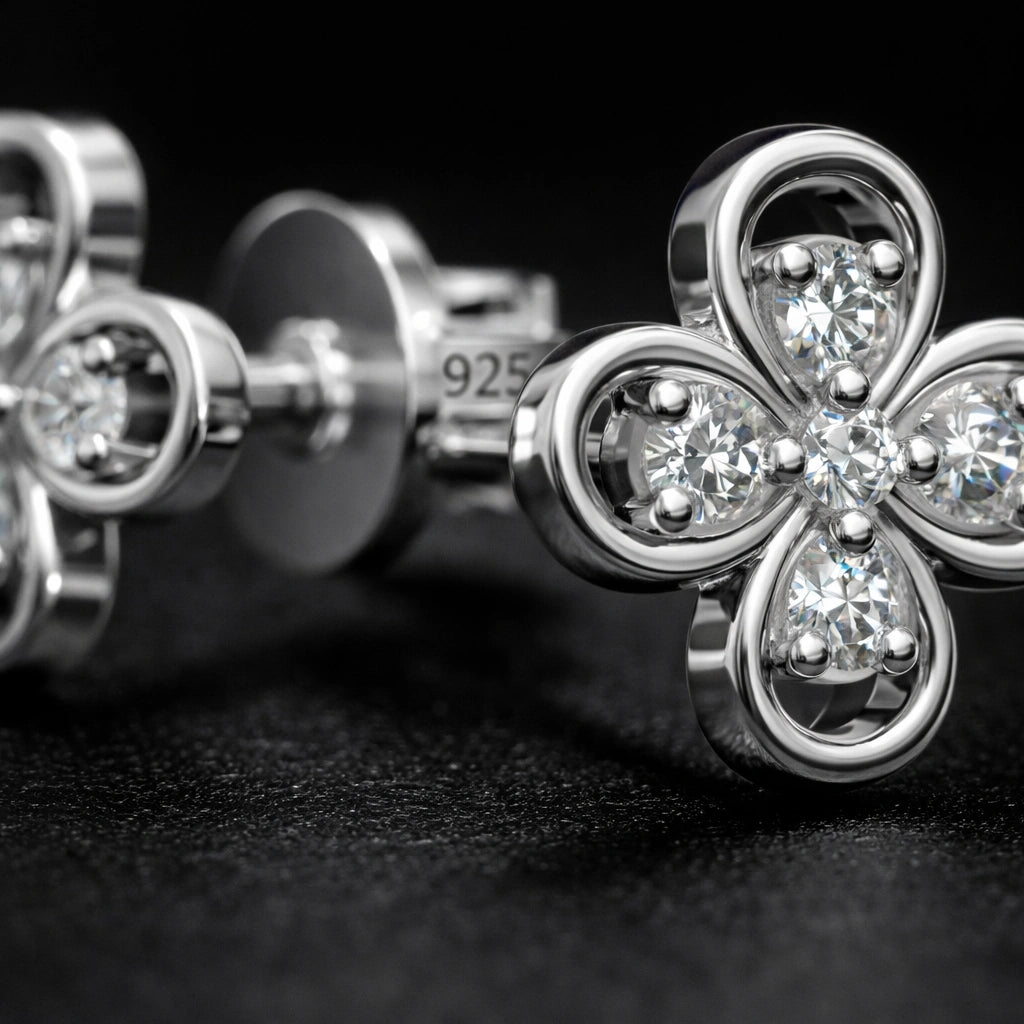 Macro detail of floral diamond stud earrings showing 925 sterling silver hallmark and precision stone setting