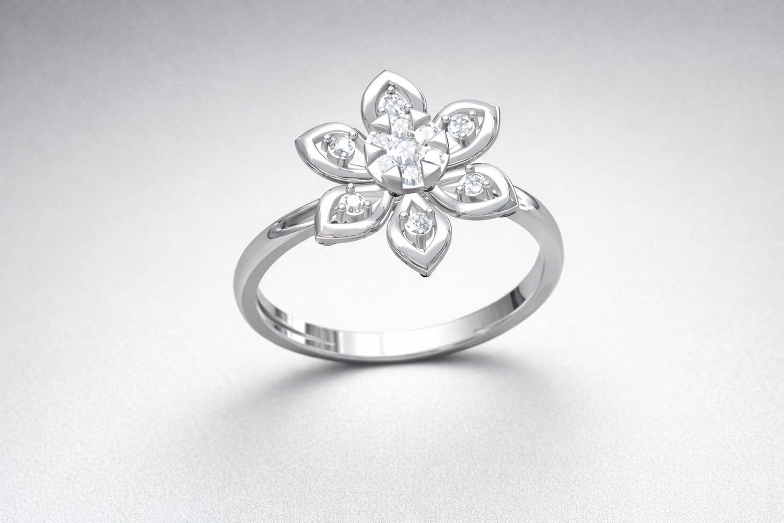 Silver ring with a floral design on a light gray background