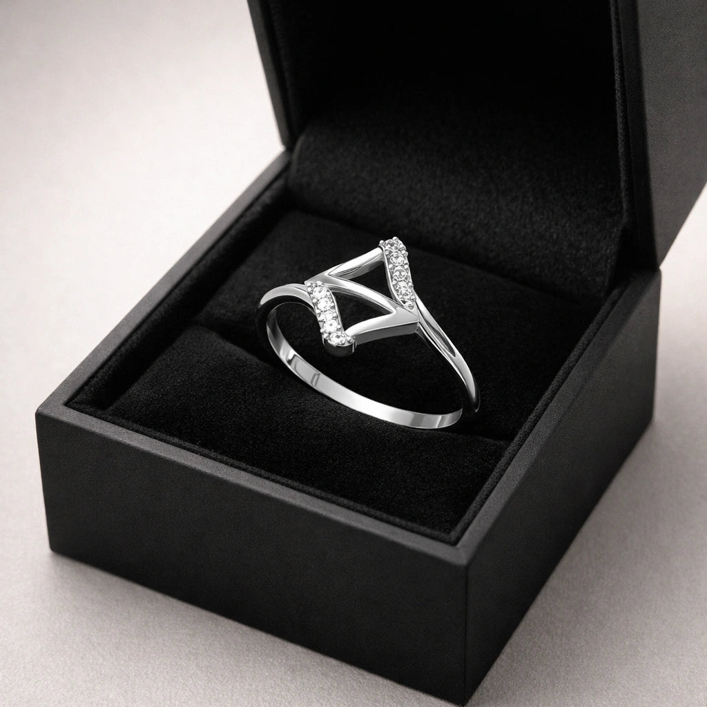 Silver ring with diamonds in a black jewelry box on a light gray background