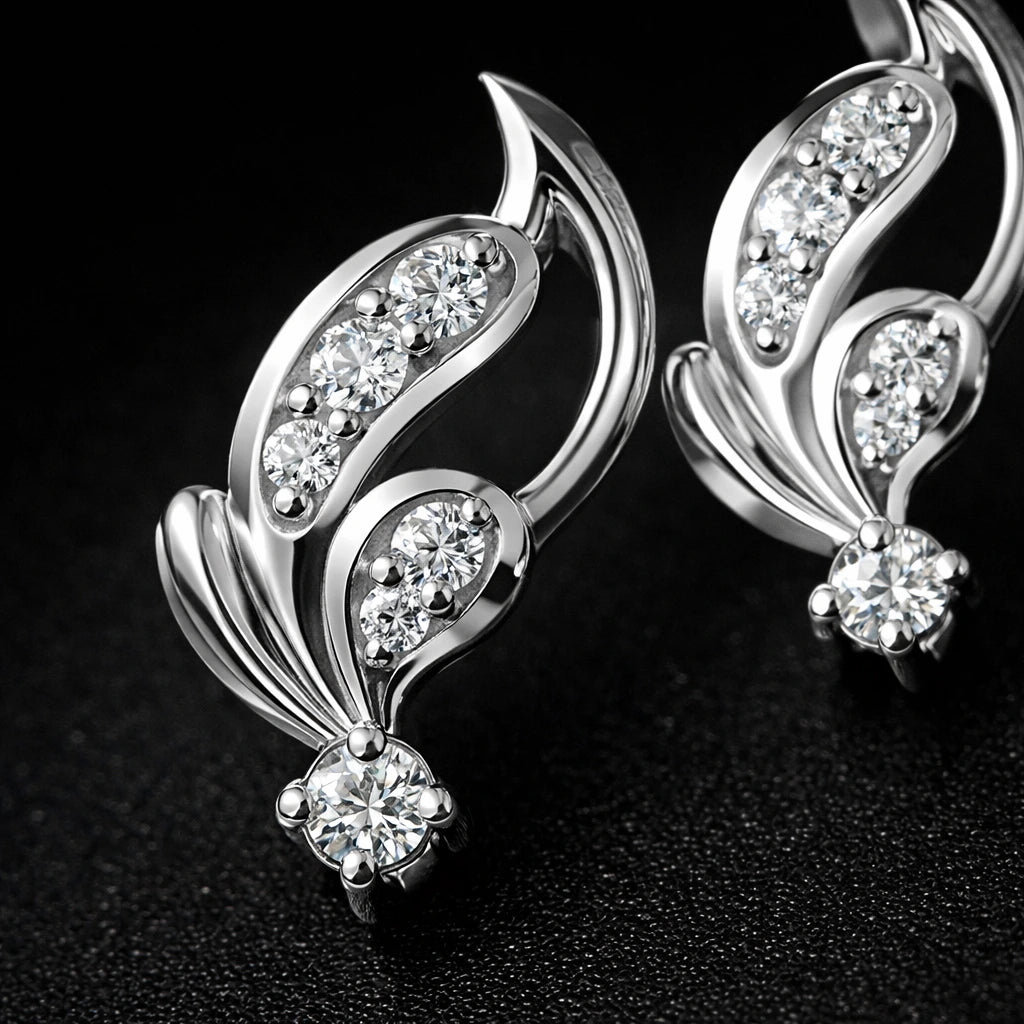 Silver earrings with diamond-like stones on a dark background