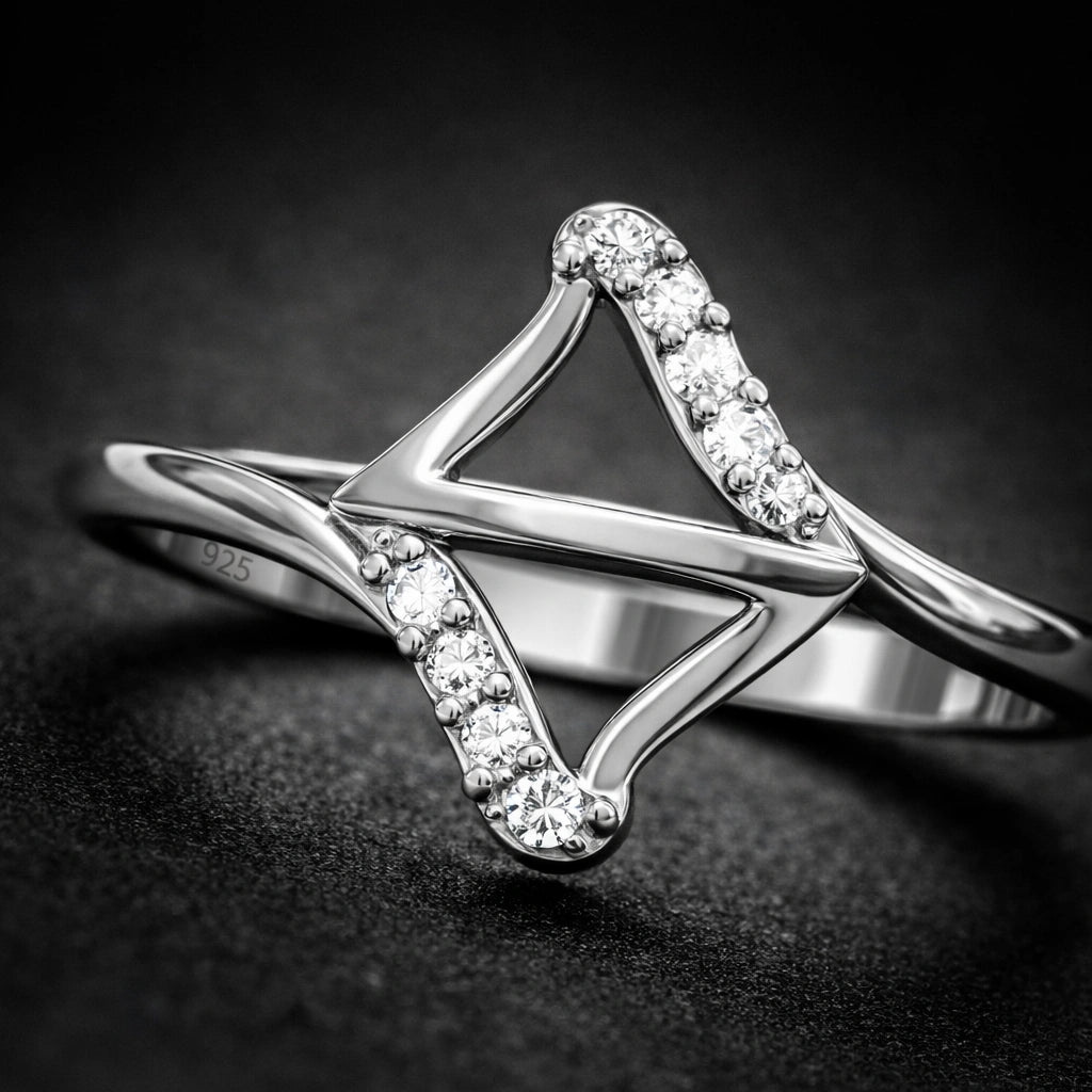 Silver ring with diamond accents on a dark background