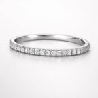 Silver ring with small diamonds on a white background