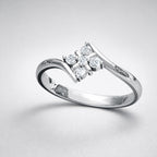 Silver ring with diamond accents on a light gray background