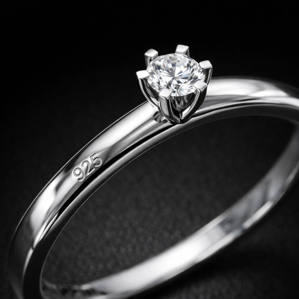 Silver ring with a diamond on a black background