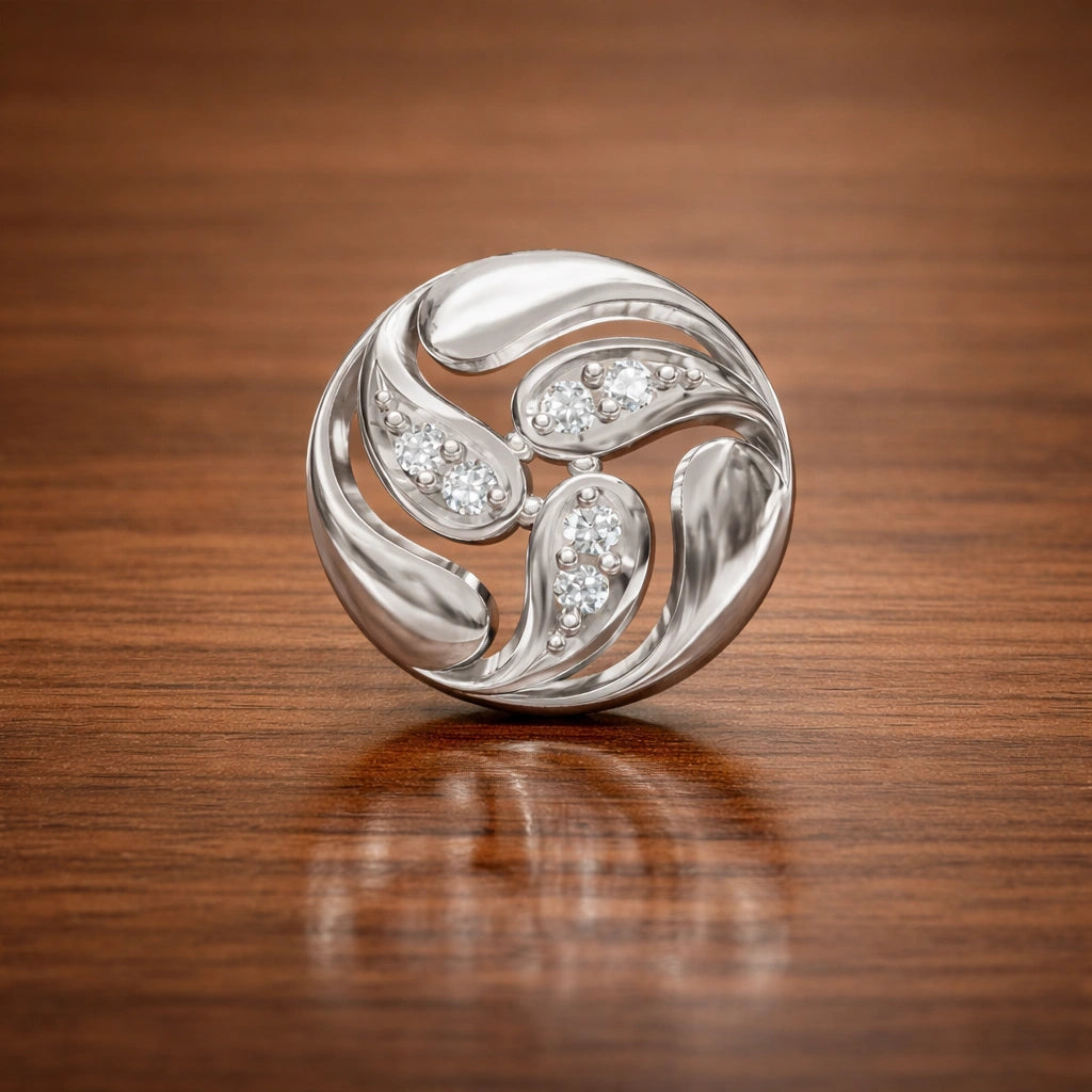 Silver brooch with gemstones on a wooden surface