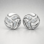 Pair of silver earrings with diamond accents on a light gray background