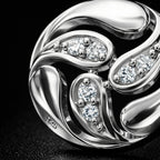 Silver ring with diamond accents on a black background