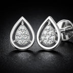 Teardrop-shaped silver earrings with clear gemstones on a dark background