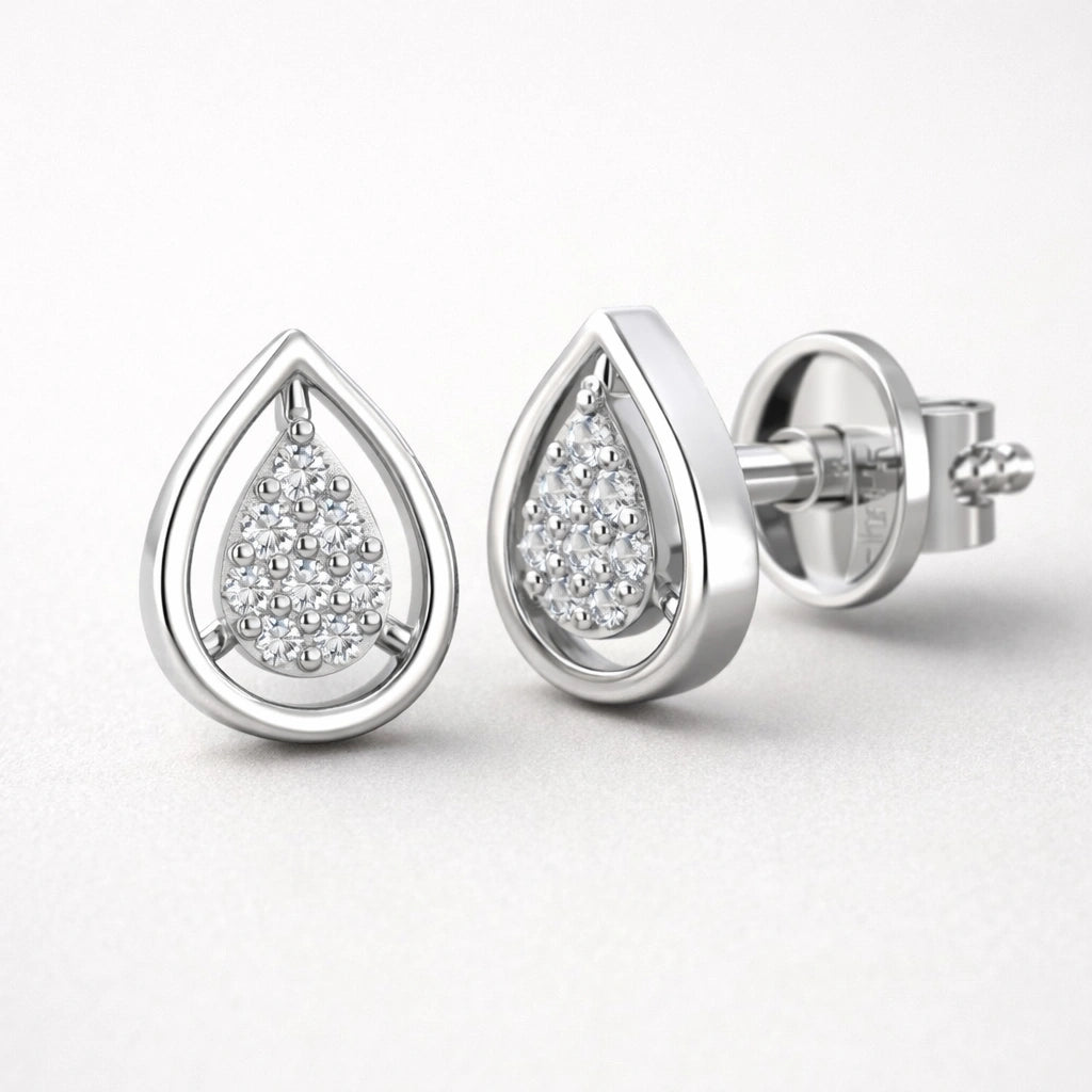 Teardrop-shaped silver earrings with embedded diamonds on a white background