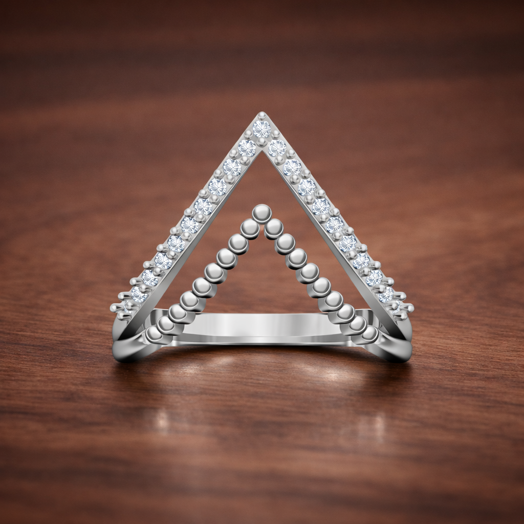 Triangular silver ring with diamond accents on a wooden surface