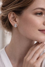 Close-up of a woman wearing a heart-shaped earring with a blurred background