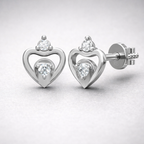 Heart-shaped silver earrings with clear gemstones on a light gray background