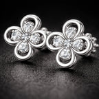 Close-up of Bloomette floral diamond stud earrings on black background highlighting sparkle and premium design