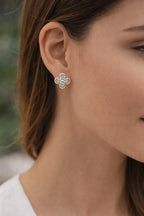 Floral diamond stud earrings worn on ear showing elegant size and everyday wear look
