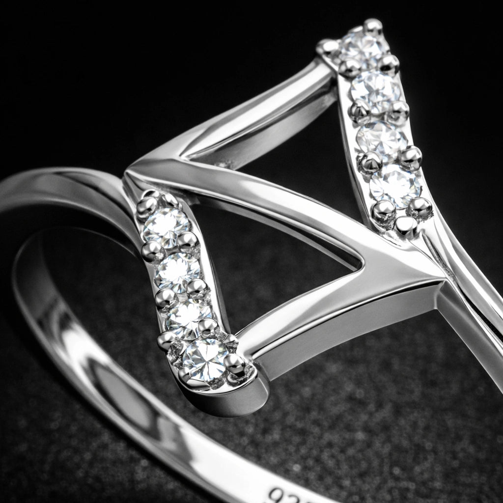 Silver ring with diamond accents on a dark background