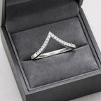 Silver ring with diamonds in a gray jewelry box