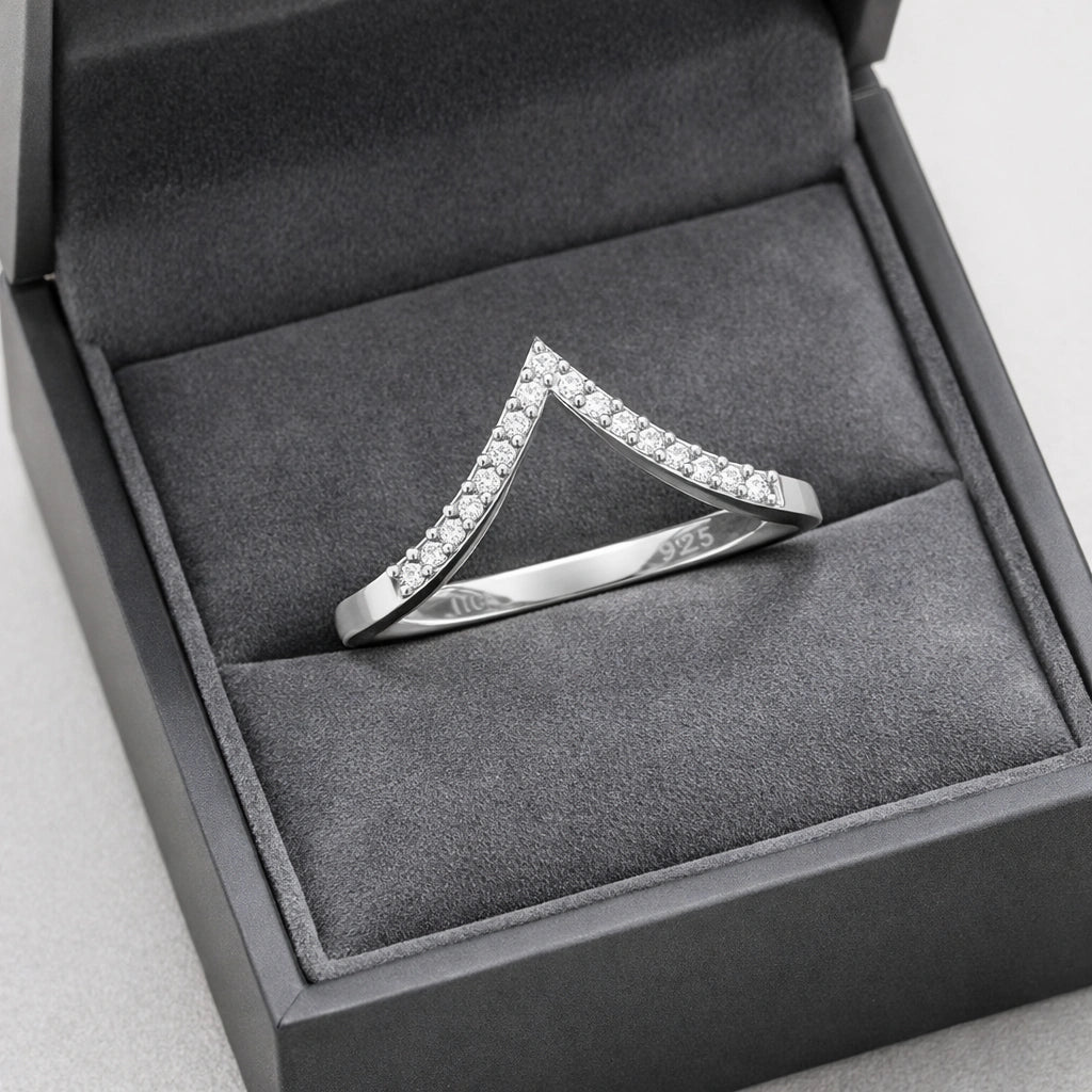 Silver ring with diamonds in a gray jewelry box