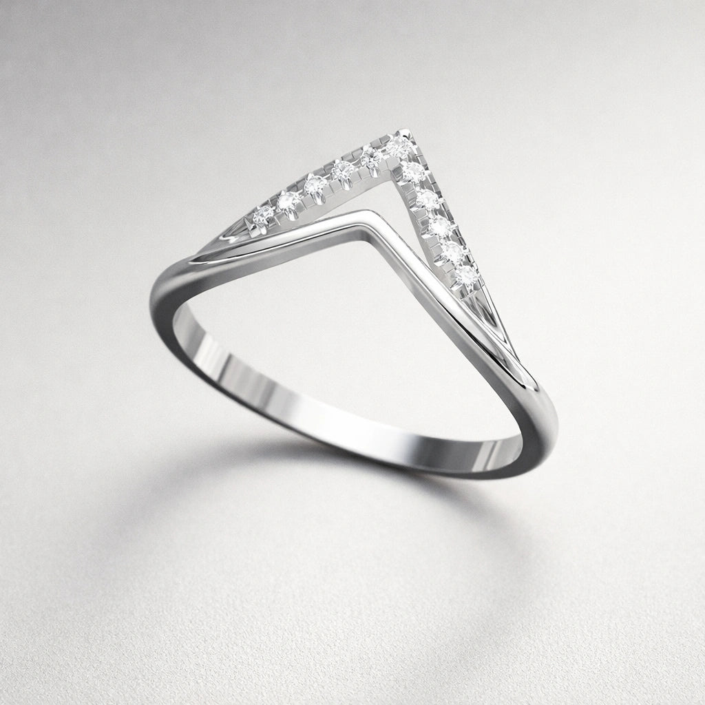 Diamond ring with a triangular stone on a light gray background