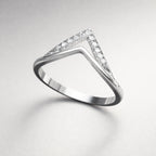 Diamond ring with a triangular stone on a light gray background