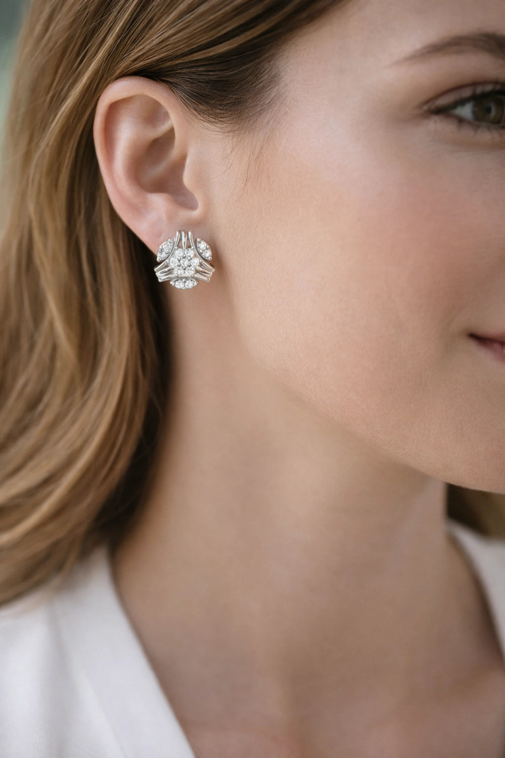 Close-up of a woman wearing a silver earring with a blurred background