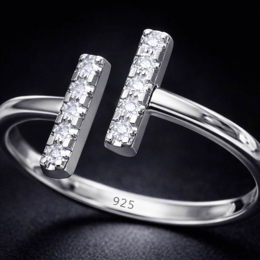 Silver ring with diamond accents on a dark background