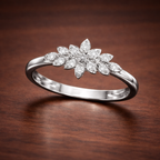 Silver ring with floral diamond design on a wooden surface