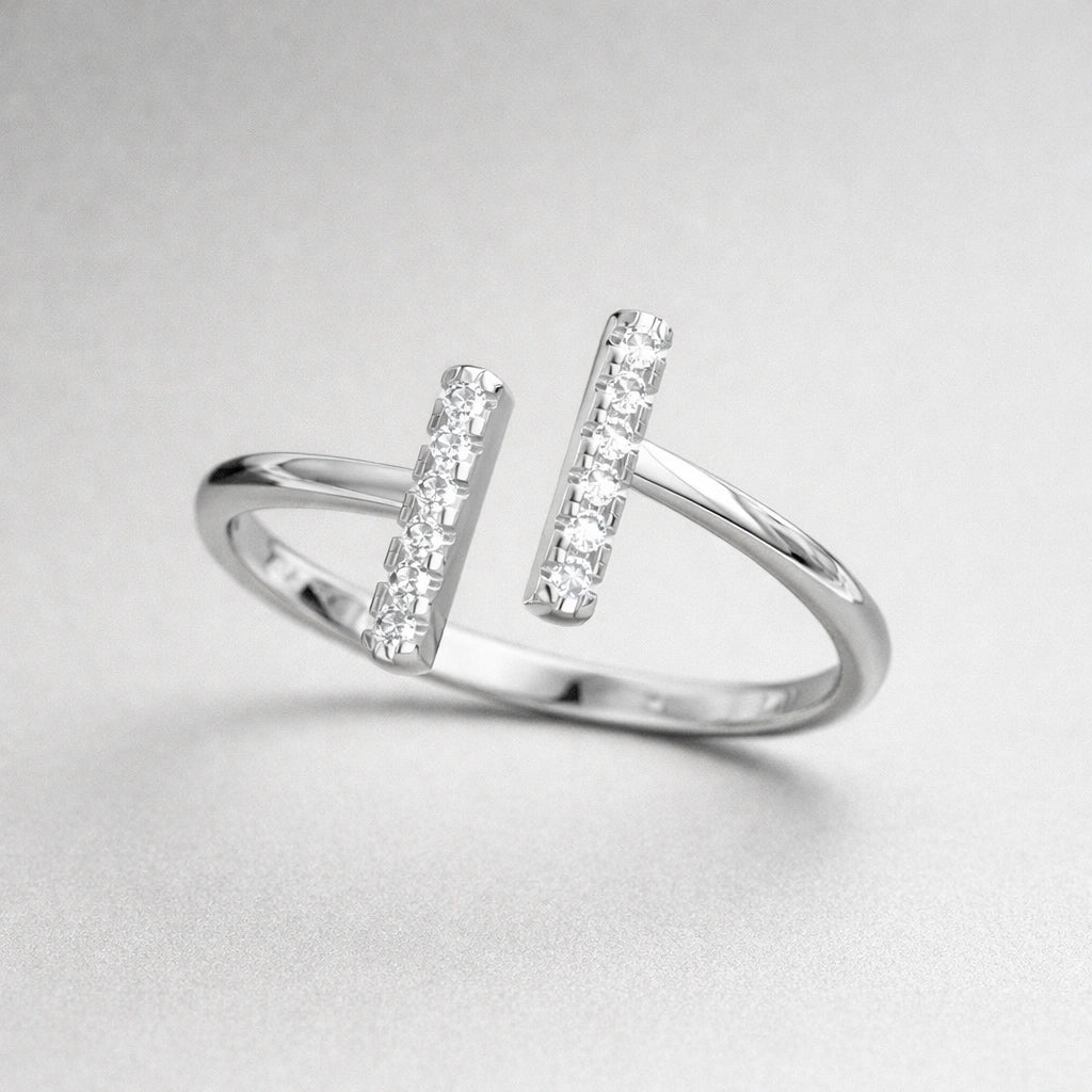 Silver ring with diamond accents on a light gray background