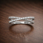 Silver ring with diamonds on a wooden surface