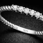 Silver bracelet with diamond-like stones on a dark background