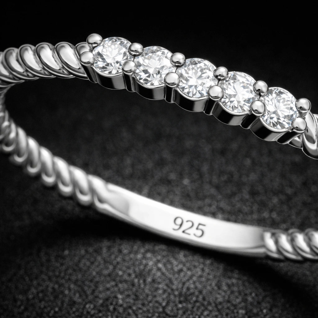 Silver bracelet with diamond-like stones on a dark background