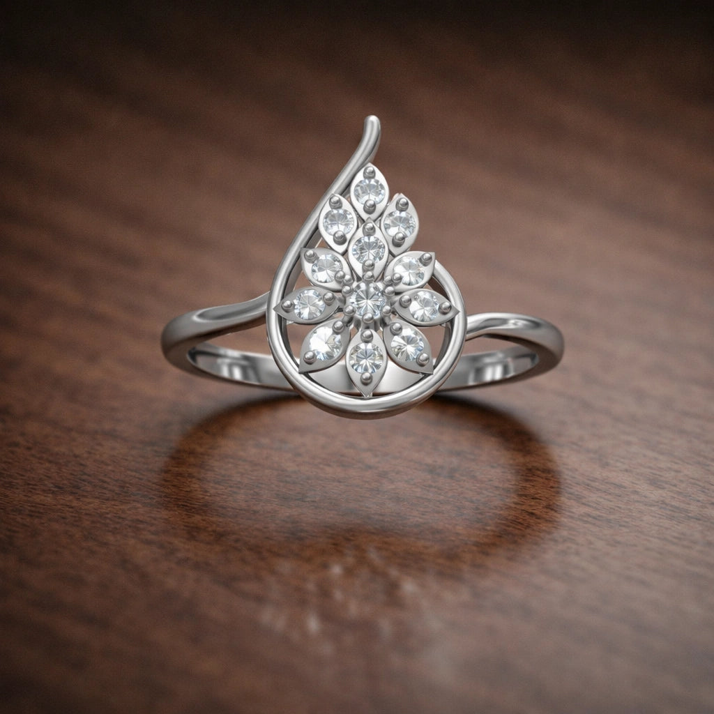 Silver ring with floral design on a wooden surface