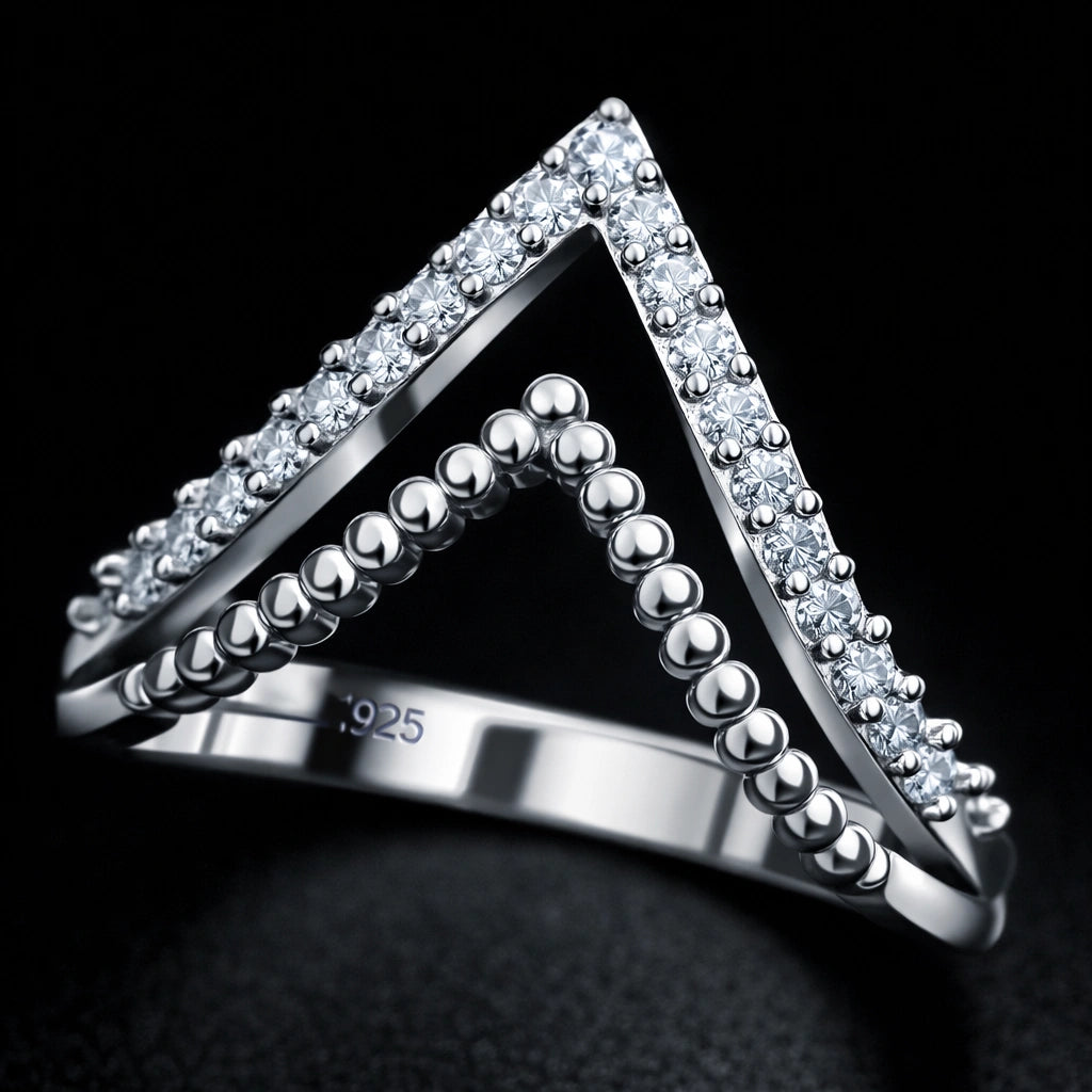 Silver triangle-shaped ring with embedded stones on a black background