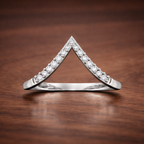 Diamond triangle ring on a wooden surface